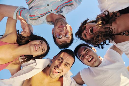 happy young friends group have fun and celebrate while jumping and running on the beach at the sunset