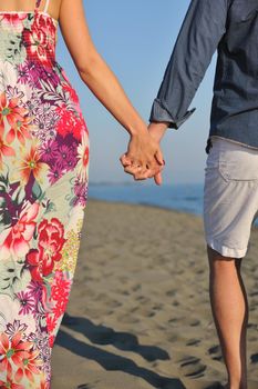 couple on beach with travel bag representing freedom and funy honeymoon concept