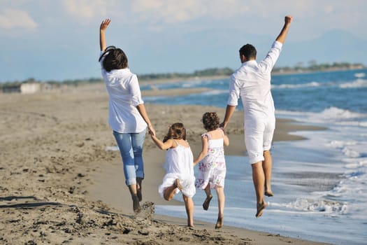 happy young family in white clothing have fun at vacations on beautiful beach 