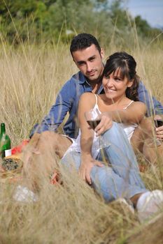 happy young couple enjoying  picnic on the countryside in the field  and have good time