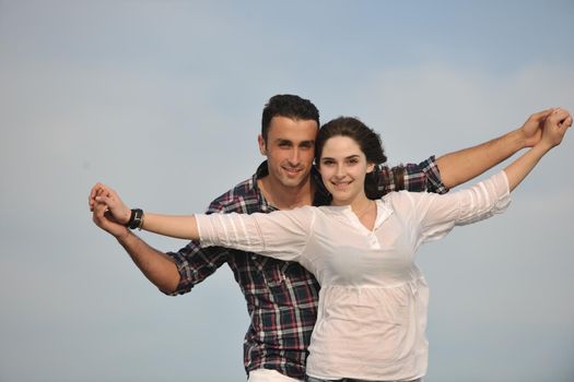 happy young couple have fun and romantic moments on beach at summer season and representing happynes and travel concept