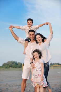 happy young family have fun and live healthy lifestyle on beach