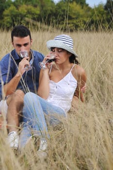 happy young couple enjoying  picnic on the countryside in the field  and have good time