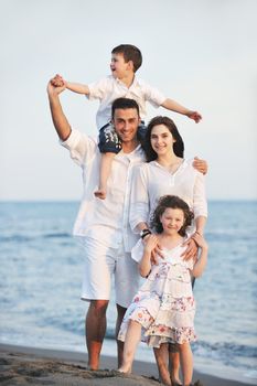 happy young family have fun and live healthy lifestyle on beach