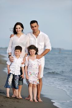 happy young family have fun and live healthy lifestyle on beach