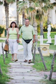 happy senior mature elderly people couple have romantic time on beach at sunset 