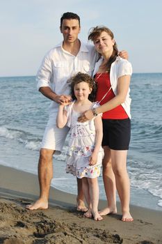 happy young family have fun and live healthy lifestyle on beach