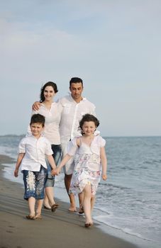 happy young family have fun and live healthy lifestyle on beach