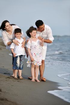 happy young family have fun and live healthy lifestyle on beach