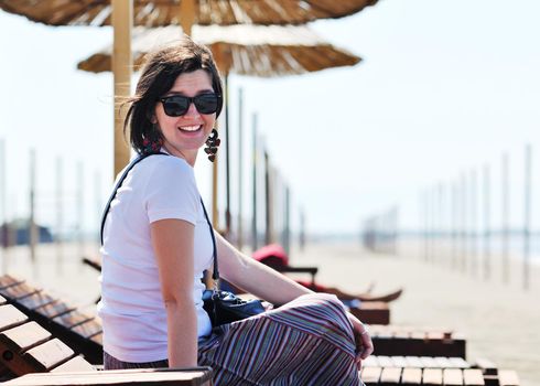 happy young woman relax on beautiful  beach at fresh summer morning and enjoy first ray of sun