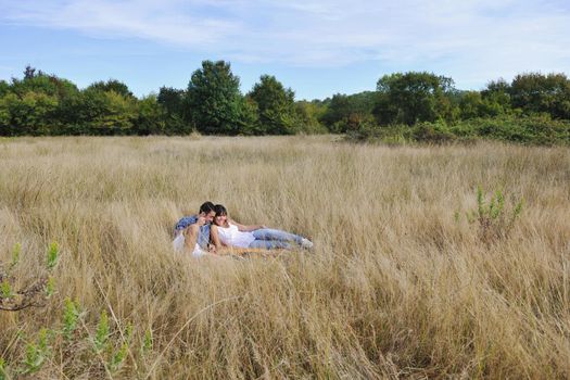 happy young couple enjoying  picnic on the countryside in the field  and have good time
