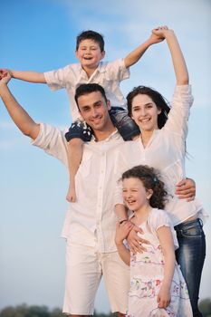 happy young family have fun and live healthy lifestyle on beach