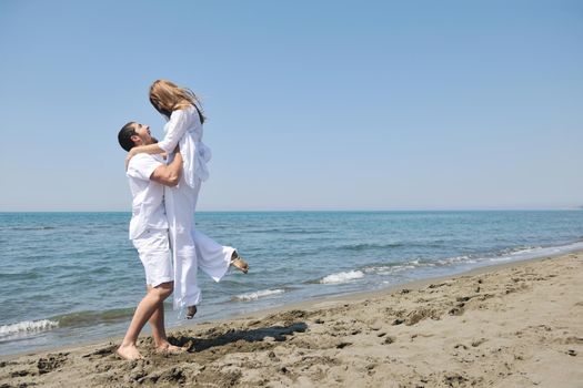 happy young couple have fun and romantic moments on beach at summer season and representing happynes and travel concept