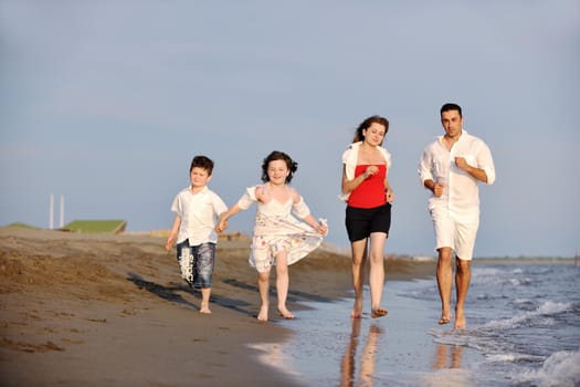 happy young family have fun and live healthy lifestyle on beach