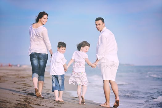 happy young family have fun and live healthy lifestyle on beach