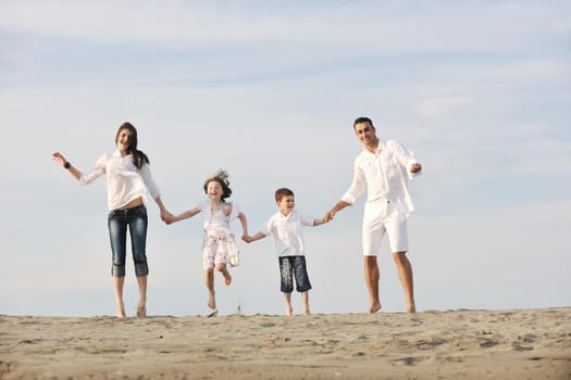 happy young family have fun and live healthy lifestyle on beach