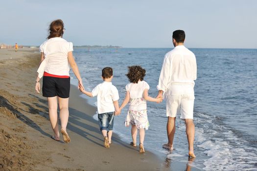 happy young family have fun and live healthy lifestyle on beach