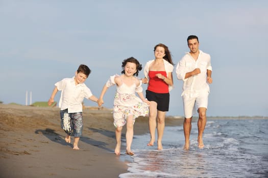 happy young family have fun and live healthy lifestyle on beach