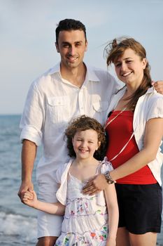 happy young family have fun and live healthy lifestyle on beach