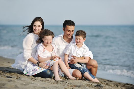 happy young family have fun and live healthy lifestyle on beach