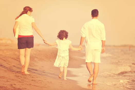 happy young family have fun and live healthy lifestyle on beach