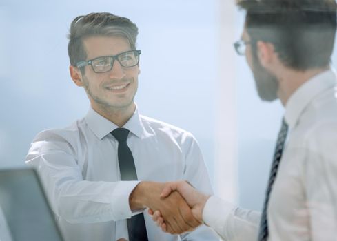 close up.business people shaking hands over a Desk.concept of partnership