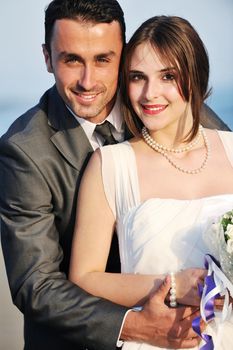 happy just married young couple celebrating and have fun at beautiful beach sunset