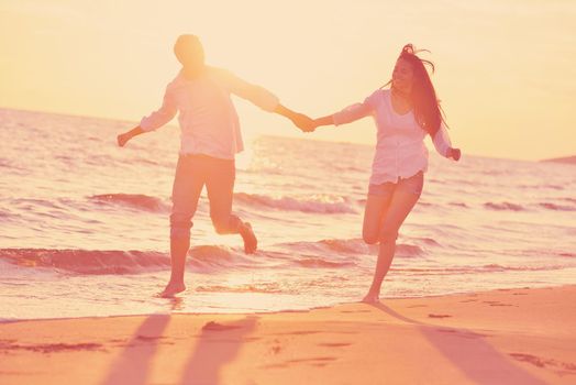 happy young romantic couple in love have fun on beautiful beach at beautiful summer day