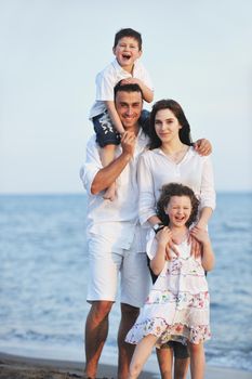 happy young family have fun and live healthy lifestyle on beach