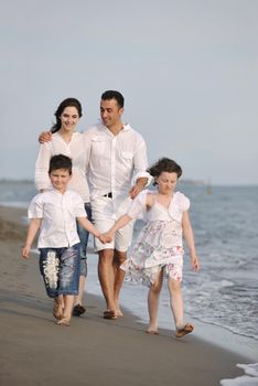 happy young family have fun and live healthy lifestyle on beach