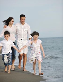 happy young family have fun and live healthy lifestyle on beach