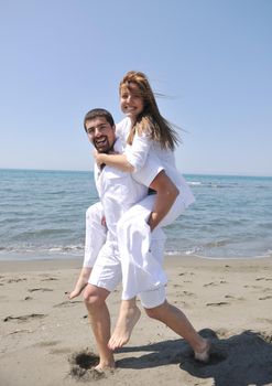 happy young couple have fun and romantic moments on beach at summer season and representing happynes and travel concept