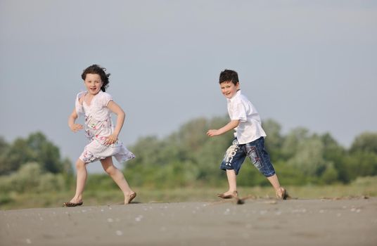 happy child kids have fun and play games on beach