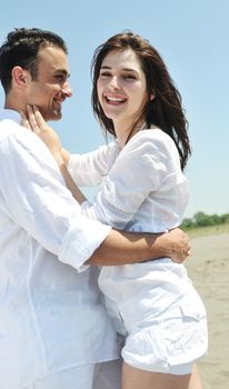 happy young couple have fun and romantic moments on beach at summer season and representing happynes and travel concept