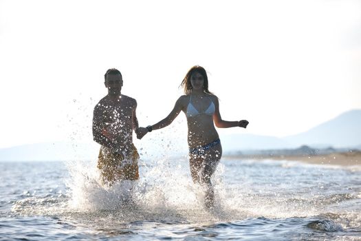 happy young couple have fun and romantic moments on beach at summer season and representing happynes and travel concept