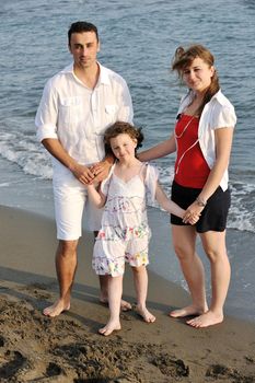 happy young family have fun and live healthy lifestyle on beach