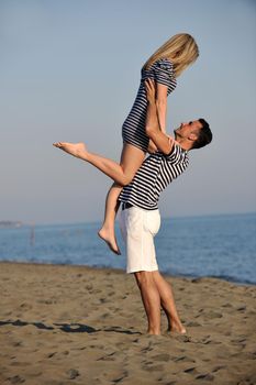 happy young couple have fun and romantic moments on beach at summer season and representing happynes and travel concept