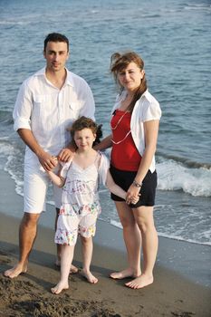 happy young family have fun and live healthy lifestyle on beach