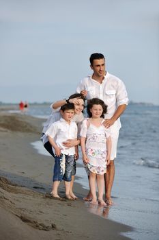 happy young family have fun and live healthy lifestyle on beach