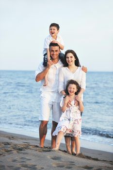 happy young family have fun and live healthy lifestyle on beach