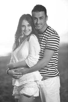 happy young couple have romantic time on beach at sunset