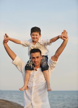 happy young family have fun and live healthy lifestyle on beach