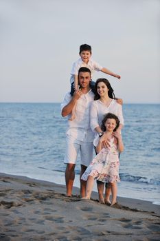 happy young family have fun and live healthy lifestyle on beach