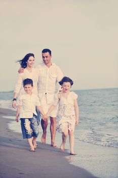 happy young family have fun and live healthy lifestyle on beach