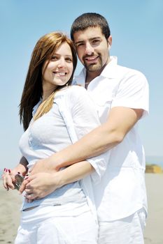 happy young couple have fun and romantic moments on beach at summer season and representing happynes and travel concept