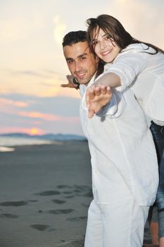 happy young couple have fun and romantic moments on beach at summer season and representing happynes and travel concept