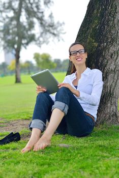 Beautiful young student  woman study with tablet in park