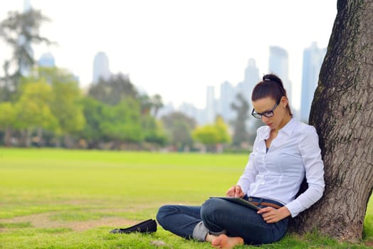 Beautiful young student  woman study with tablet in park