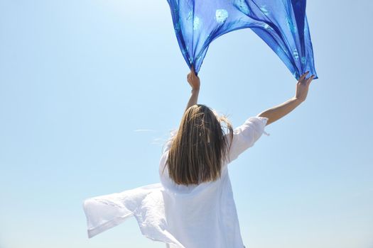 beautiful young woman on beach with scarf relax smile and have fun