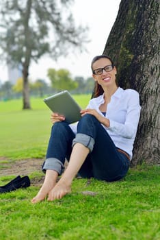 Beautiful young student  woman study with tablet in park